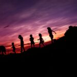 silhouette of children's running on hill